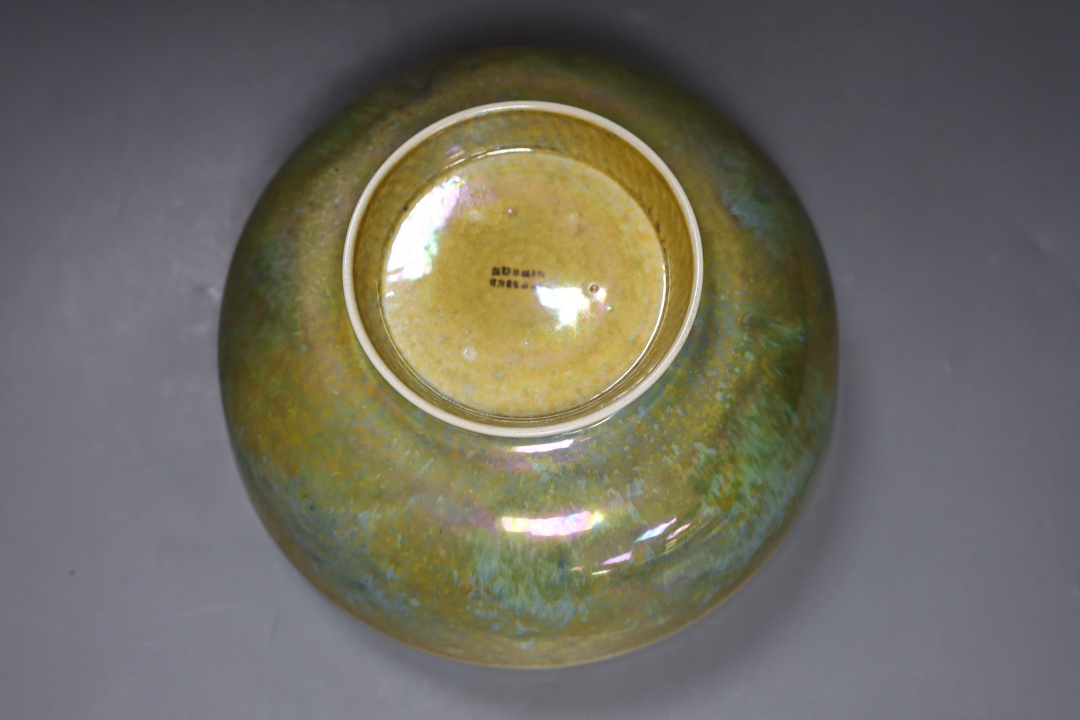 A Ruskin thinly potted green and ochre lustre fruit bowl, dated 1923, 25cm diameter